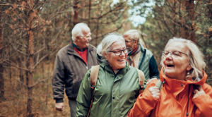 group of older people walking together in woods